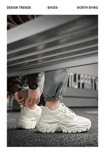 Detailed view of cream thick-sole sneakers with multi-material stitching on urban metal bench