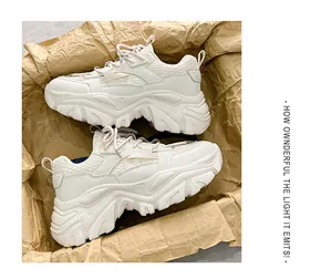 Top-down view of cream chunky sneakers on vintage paper with mesh and leather detail