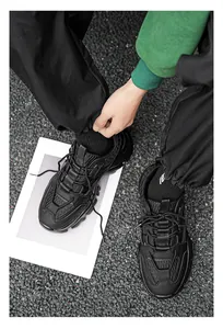 Top view of all black chunky dad shoes featuring leather and mesh stitching textures
