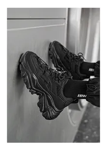 Detail view of all-black chunky sneakers featuring mesh panels and thick anti-slip soles