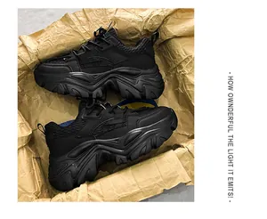 Detail of all-black chunky sneakers showing leather textures and thick rugged outsoles