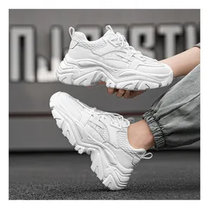 Detail view of white chunky sneakers with breathable mesh upper and sculpted thick sole
