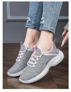 Close-up of breathable mesh fabric and pink detailing on women casual sneakers