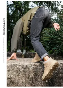 Outdoor khaki hiking boot side profile showing durable non-slip lug sole on rocks