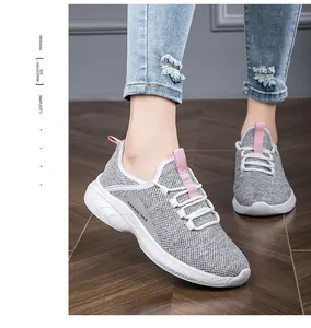 Detail of grey mesh breathable upper and pink pull tab on lightweight women's running shoe