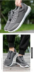 Detail of grey mesh sneakers featuring breathable fabric and quick-lace toggle system
