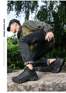 Outdoor male hiking boot detail with rugged non-slip rubber sole on natural rocky terrain