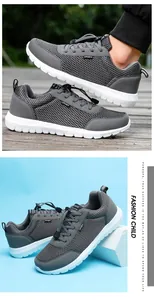 Detail of grey mesh running shoes with breathable fabric and white anti-slip soles