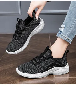 Detailed side view of breathable black and gray mesh running shoes with thick white soles