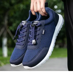 Detail view of breathable navy mesh fabric and quick-lace system on men's sport shoe