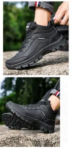 Close-up of black men's outdoor hiking boots with thick non-slip rubber soles on rocks