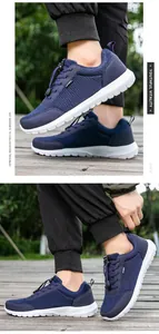 Detail of navy breathable mesh running shoes with SPORT logo and quick lace system