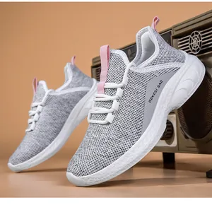 Close-up of breathable grey mesh upper and pink pull tab on women running sneakers
