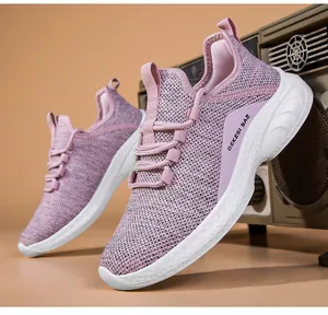 Detail of pink knitted mesh running shoe showing breathable fabric and GEKESI SAE logo