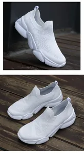Detail of white flyknit slip-on sneakers with breathable mesh and thick PU sole