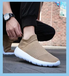 Detailed close-up of tan knit sock sneakers with flexible breathable mesh and white soles