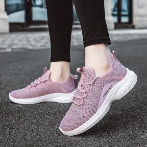 Women's lavender breathable mesh running shoes with white cushioned soles on street background