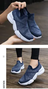 Close-up of deep blue knitted slip-on sneakers with silver glitter and thick white sole