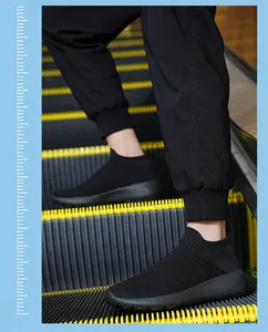 Detail view of black knit slip-on sneakers with elastic texture and thick sole