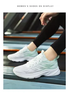Detail of women's breathable mesh running shoe in light green on a treadmill