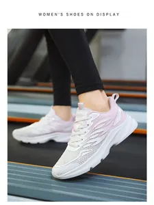 Macro view of breathable pink mesh upper and cushioned sole for women's running shoes
