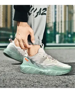 Macro detail of breathable mint green mesh running shoe with thick cushioning sole