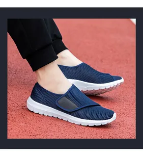 Detail of navy blue mesh sneakers with Velcro strap on an outdoor running track