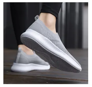 Detail of grey breathable mesh slip-on sneakers with honeycomb textured white platform sole