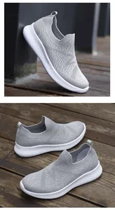 Detail view of grey knit slip-on sneakers with honeycomb textured white platform soles