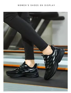 Detail of breathable mesh women's running shoes with silver flame patterns in a gym setting