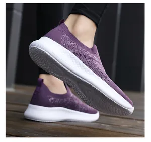 Macro view of purple breathable knit walking shoe featuring lightweight non-slip white sole