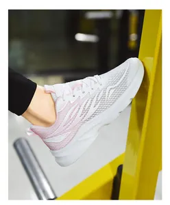 Detail of pink and white mesh running shoes showing the side design on a model feet