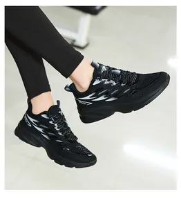 Close-up of black breathable mesh sneakers with silver flame patterns and cushioned soles