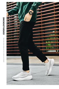Outdoor shot of men's white breathable running shoes with thick cushioned soles on feet