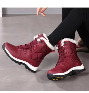 Detail view of burgundy quilted snow boot featuring thick white faux fur lining and anti-slip sole
