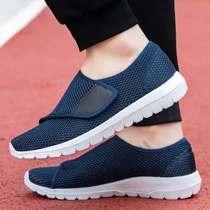 Navy blue breathable mesh slip-on sneakers with white platform soles on track