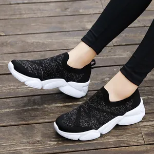 Women's lightweight black knit slip-on sneakers with starry silver sparkle and white sole