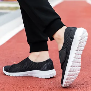 Women's breathable black mesh slip-on sneakers with lightweight white foam soles for running