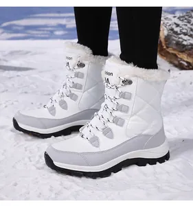 Close-up of winter snow boots featuring waterproof quilted fabric and warm faux fur lining
