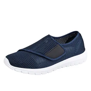 Navy blue breathable mesh sneakers with velcro straps and thick white soles for women