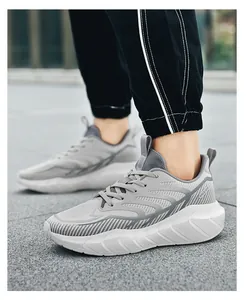 Detail of grey breathable mesh running shoes with thick white sole and non-slip tread