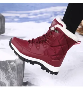 Detail view of burgundy high-top snow boot with thick faux fur lining and non-slip sole