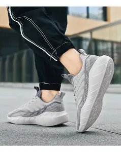 Outdoor shot showing side profile of breathable mesh running shoes with thick white soles