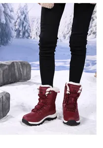 Detail of dark red waterproof snow boots with white faux fur lining in a snowy forest