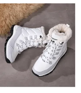 Detailed view of white snow boots with thick faux fur lining and non-slip rubber soles