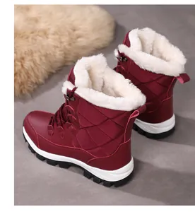 Detailed view of burgundy winter snow boots with quilted texture and thick faux fur lining