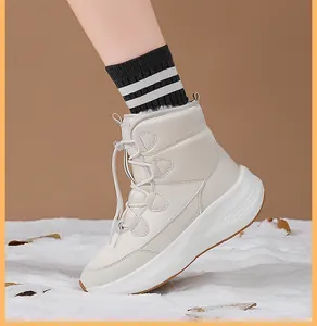 Detail of warm white snow boots with thick faux fleece lining and drawstring closure
