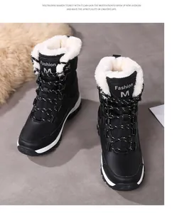 Close-up of black snow boots with thick white faux fur lining and non-slip soles