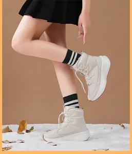Detail of warm off-white winter snow boots with thick faux fur lining and drawstring closure