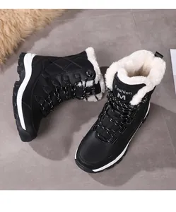 Close-up of winter snow boots with waterproof quilted upper and thick white faux fur lining